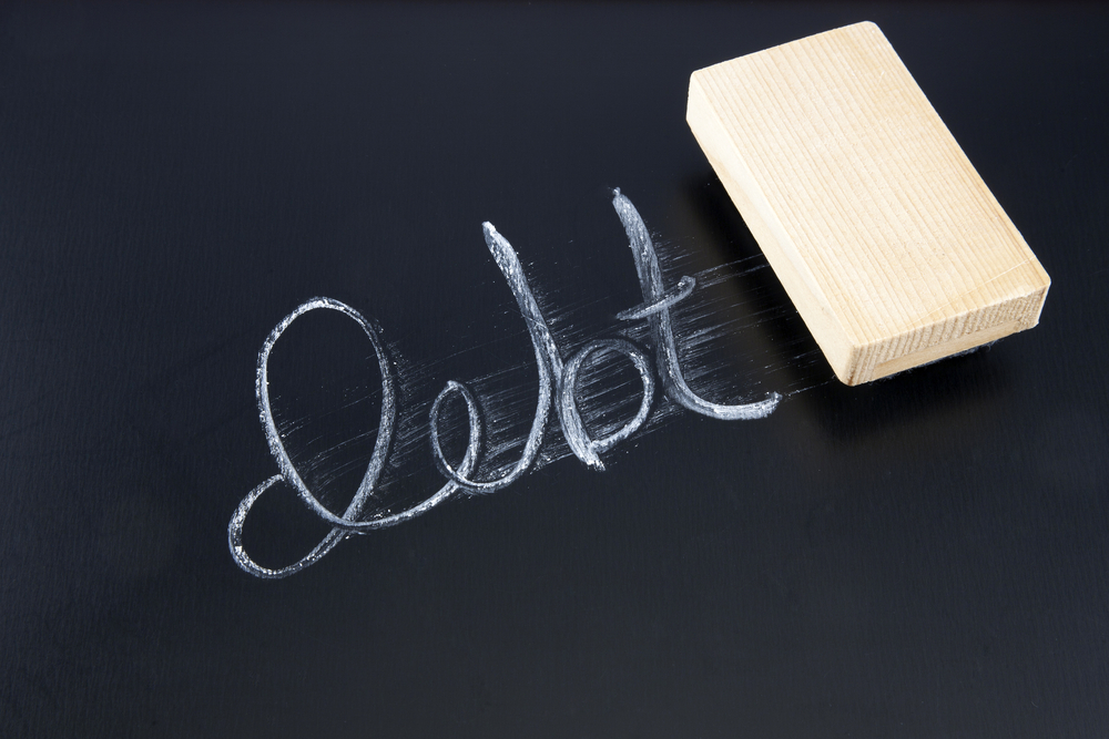 Debt written on blackboard, partially smudged away by eraser