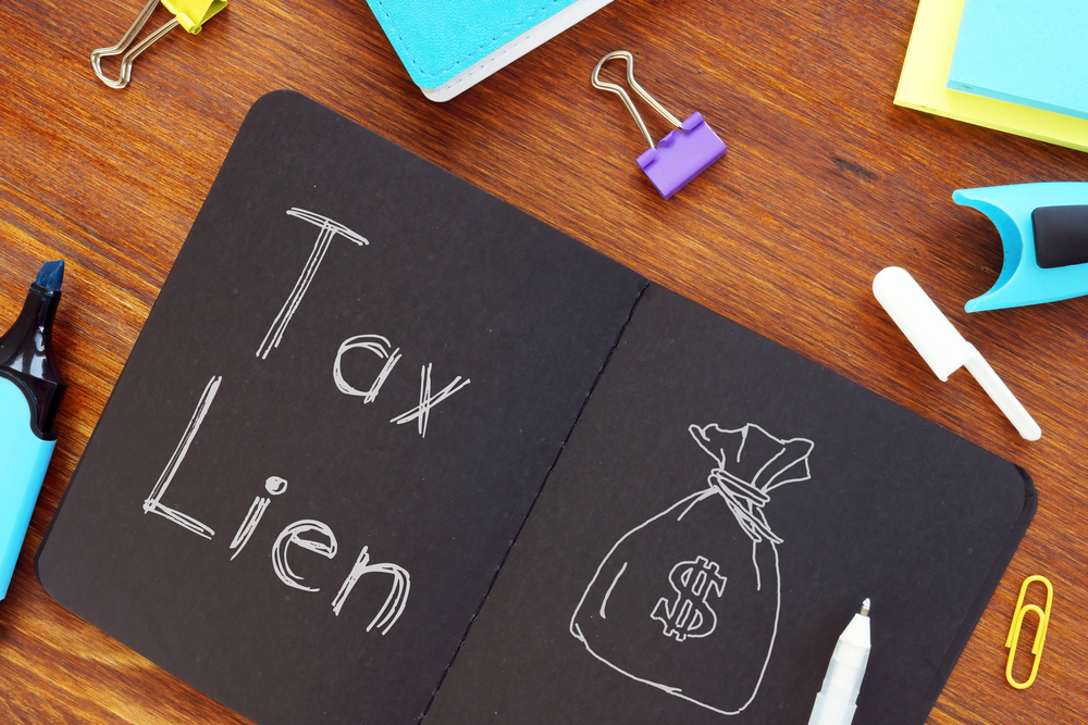 Black notebook with tax lien written and a drawing of a money sack inside