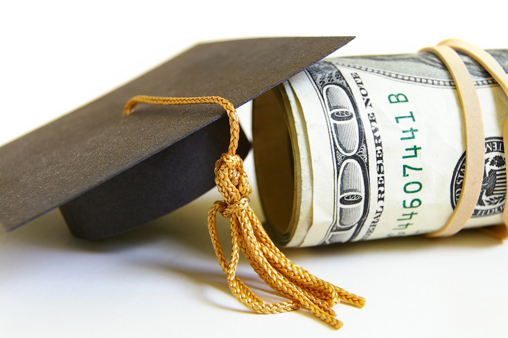 Graduation cap and roll of cash