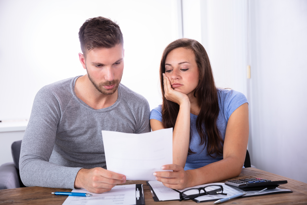 Worried couple looking over finances
